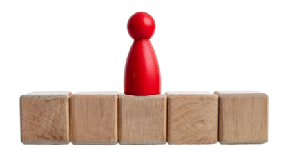 red pawn figure standing on wooden cubes, symbolizing concept of leadership and achievement. The figure is in center
