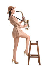 Beautiful woman playing saxophone on white background
