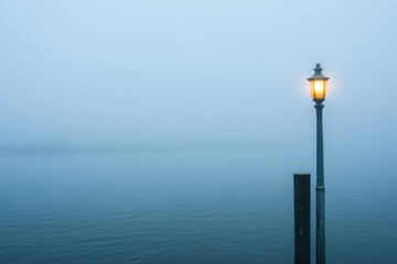 Street lamp in dense fog with eerie atmosphere and negative space on right