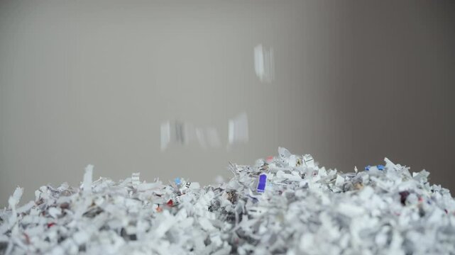 Shredded paper office documents in woman worker hands. Close up 