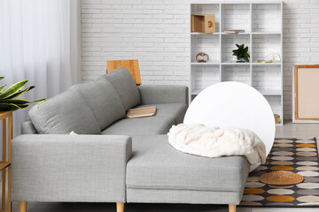 Interior of living room with grey sofa after earthquake