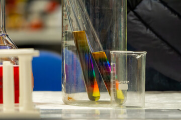 chemical experiments in chemical test tubes. chemical reaction in test tubes. colored chemicals. science demonstrations in the laboratory. mixing different dyes.
