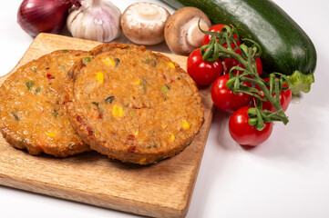 Round vegetarian patties or burgers made from grains, soybeans, vegetables and legumes