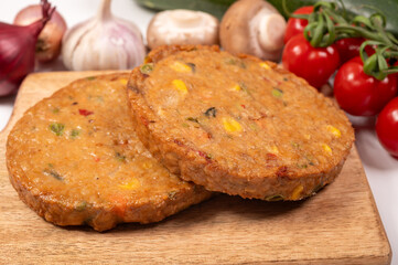 Round vegetarian patties or burgers made from grains, soybeans, vegetables and legumes