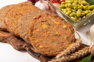 Round vegetarian patties or burgers made from grains, soybeans, vegetables and legumes