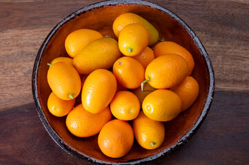 Delicious small citrus fruits orange kumquats close up