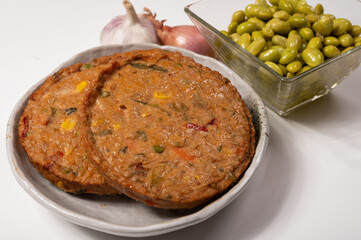 Round vegetarian patties or burgers made from grains, soybeans, vegetables and legumes