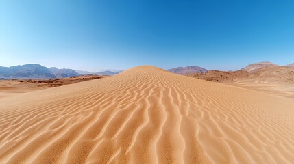 Large Sand Dune Landscape Under Clear Blue Sky with Mountain Range