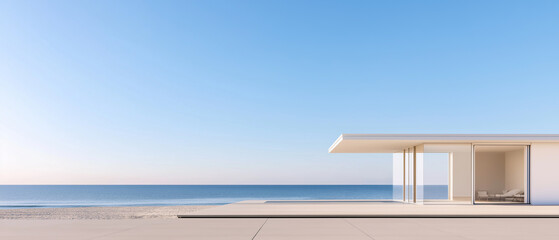 Fototapeta premium Modern house on a beach with a clear blue sky and the ocean in the background. the house is a two-story building with a white exterior and large windows on the right side.