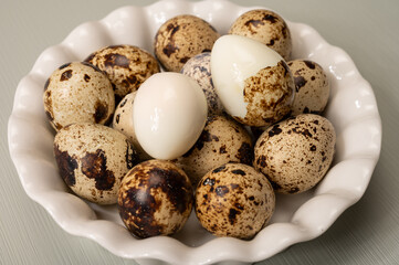 Obraz premium Fresh small spotted partridge or quail bird eggs uncooked and cooked