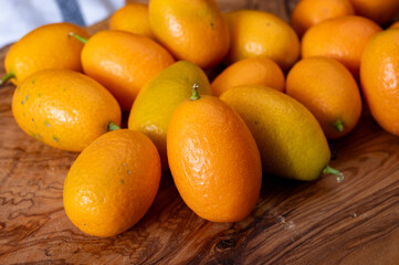 Delicious small citrus fruits orange kumquats close up