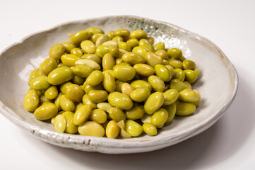 Asian vegetarian food cooked green soybeans on board