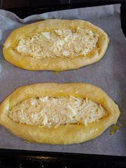 Adjarian khachapuri with sulguni cheese waiting to be baked in oven
