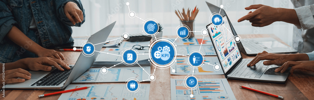 Poster A professional workspace highlights the collaborative effort of analyzing key performance metrics with laptops and visual data, emphasizing teamwork and decision-making processes. Amity
