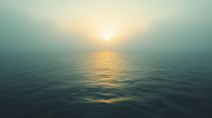 Fototapeta premium Misty sunrise over calm ocean water.