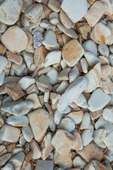 Close-up view of a pile of smooth, grey pebbles for landscaping