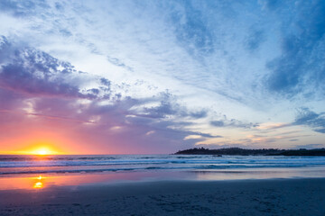 Fiery sunset over ocean waves at Carmel-by-the-Sea Beach, California