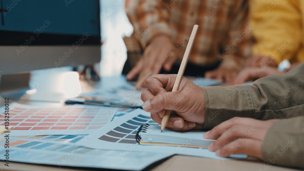 Poster close-up view of hands actively selecting colors and planning designs at a creative workspace. color