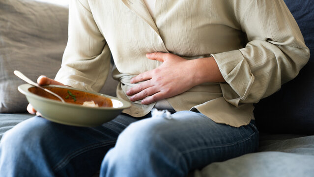 Woman with bloating and abdominal pain