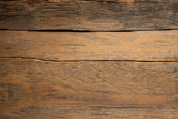 Fototapeta premium A photo of the texture of a wooden board with cracks and knots.The background is made of antique boards.