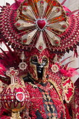 Venice, Italy - People dressed in carnival masks are photographed by tourists in the scenery of the ancient Venetian palaces