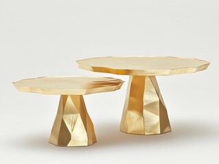 Two golden pedestal tables displayed on a white background