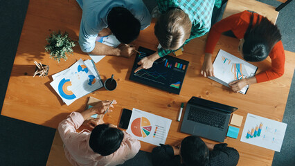 Top down view of business woman explain and present financial chart. Diverse group discuss and...