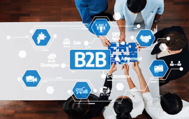 Diverse team members collaborate on a B2B agreement using puzzle pieces to symbolize partnership,...