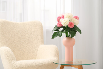 Vase with beautiful dahlia flowers on table in living room