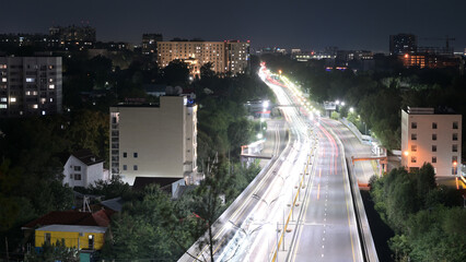 Long exposure car lights traces on highway in the night. Almaty