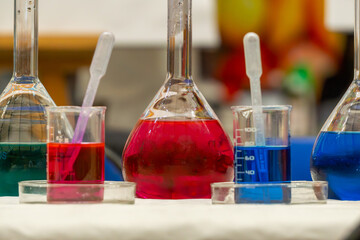 chemical experiments in chemical test tubes. chemical reaction in test tubes. colored chemicals. science demonstrations in the laboratory. mixing different dyes.