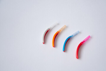 Toothbrushes and interdental brush on the white background. Dental and orthodontic concept.