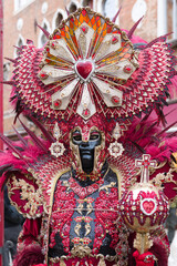 Venice, Italy - People dressed in carnival masks are photographed by tourists in the scenery of the ancient Venetian palaces