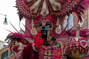 Venice, Italy - People dressed in carnival masks are photographed by tourists in the scenery of the...