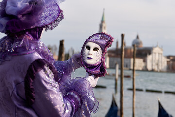 Venice, Italy - People dressed in carnival masks are photographed by tourists in the scenery of the...