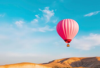 Obraz premium Pastel pink hot air balloon ascends against a vibrant blue sky, flight, view