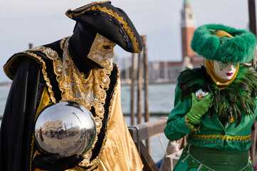 Venice, Italy - People dressed in carnival masks are photographed by tourists in the scenery of the...