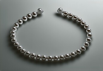 Obraz premium Elegant Silver and Pearl Necklace Displayed on a Smooth Surface Capturing Soft Light Reflections