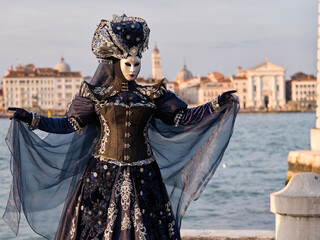 Venice, Italy - People dressed in carnival masks are photographed by tourists in the scenery of the ancient Venetian palaces © Renato68