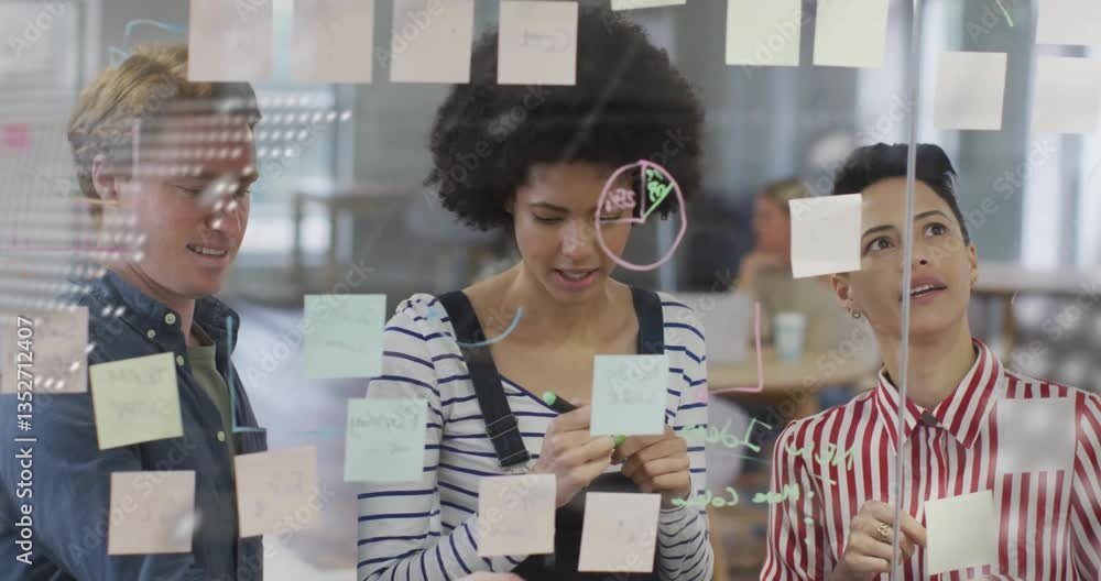 Poster brainstorming with sticky notes and digital data overlay, diverse team collaborating