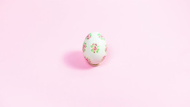 Preparing white eggs for Easter using decoupage technique using napkins. Pink background. Copy space. Stop motion animation.