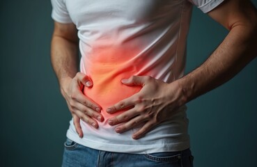 Man holds stomach, suffering abdominal pain. Hands on belly indicate ache, discomfort, medical issue. Health problem, illness, sickness concept. Healthcare, medicine, symptom of disease.