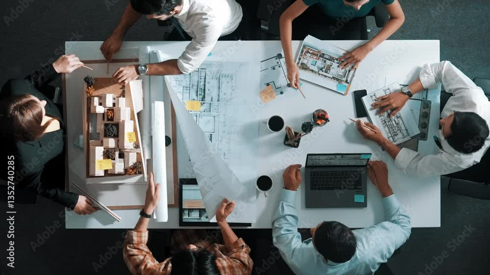 Poster group of diverse team planning strategy while sitting at table with project plan. top aerial view of