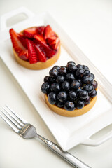 Close up of French Blackberry and Strawberry Tarts