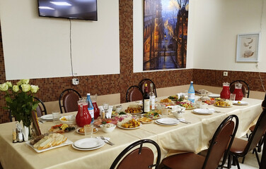 Festive dining setup with abundant food and elegant decor in a cozy restaurant environment