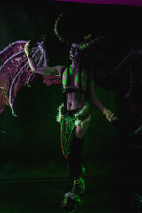 Demon Hunter Demon Cosplay on Black Background in Green Light