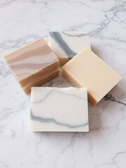 Handmade natural soap bars arranged on a marble surface
