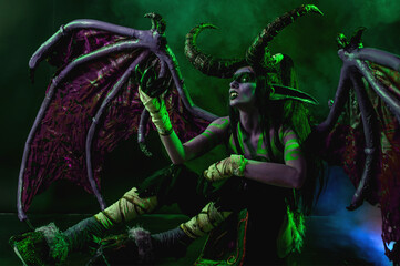 Demon Hunter Demon Cosplay on Black Background in Green Light