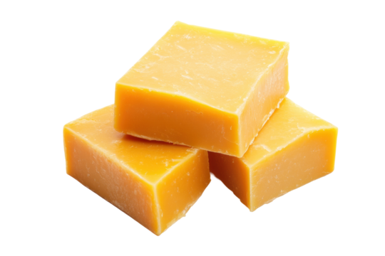 Three yellow cheddar cheese blocks stacked on white surface, cut out