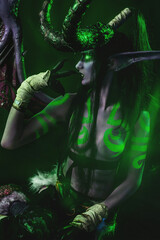 Demon Hunter Demon Cosplay on Black Background in Green Light
